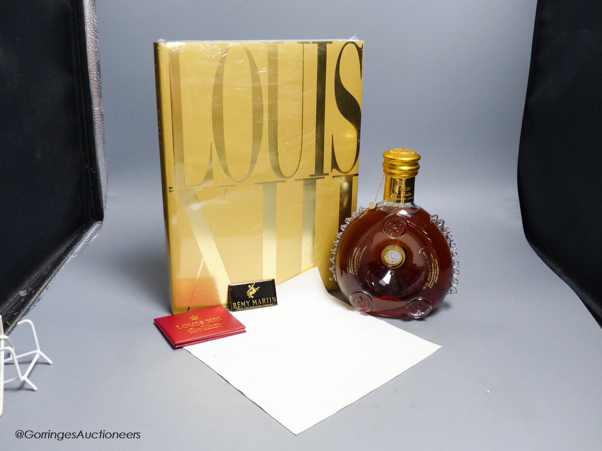 A sealed bottle of Louis XIII Remy Martin Grand Champagne Cognac, Carafe No.DJ9508, with original cloth and a sealed copy of Louis XIII Cognac The Thesaurus